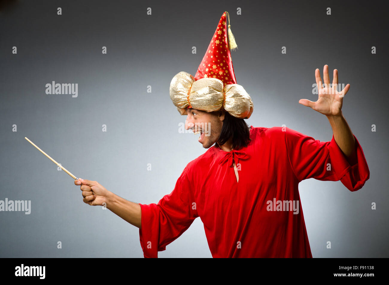 Funny wizard wearing red dress Stock Photo - Alamy
