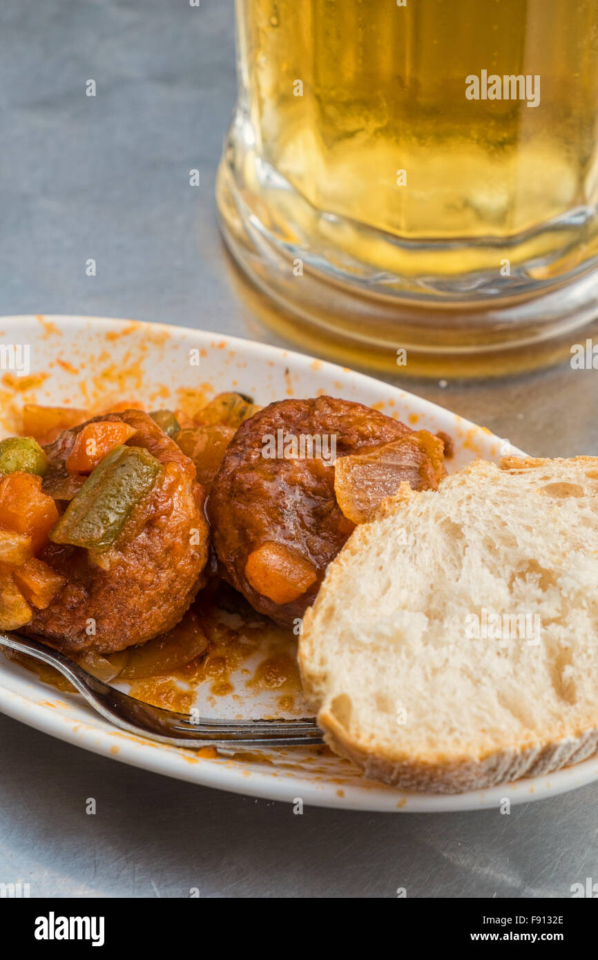 Traditional Spanish meatball tapa served with a glass of beer Stock
