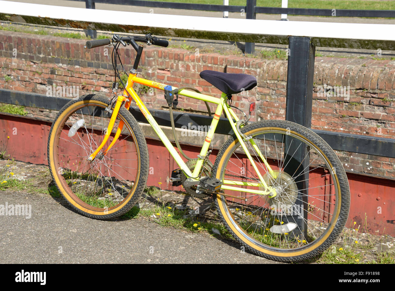Mountain bike locked by Grand Union Canal, Stoke Bruerne, Northamptonshire, England, United Kingdom Stock Photo