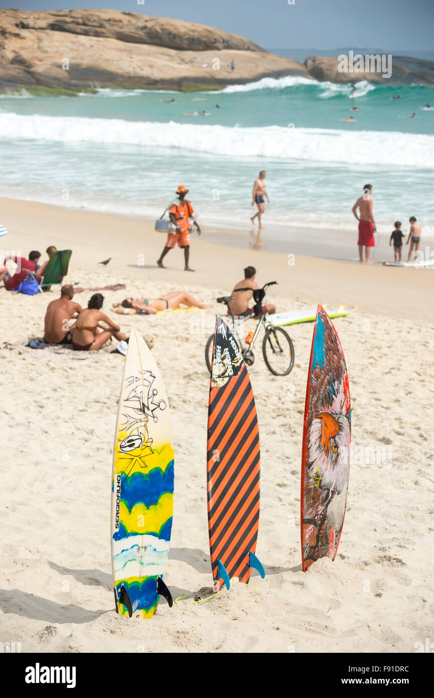 RIO DE JANEIRO, BRAZIL - MARCH 22, 2015: Colorfully patterned stand up paddle surfboards stand lined up on the beach at Arpoador Stock Photo
