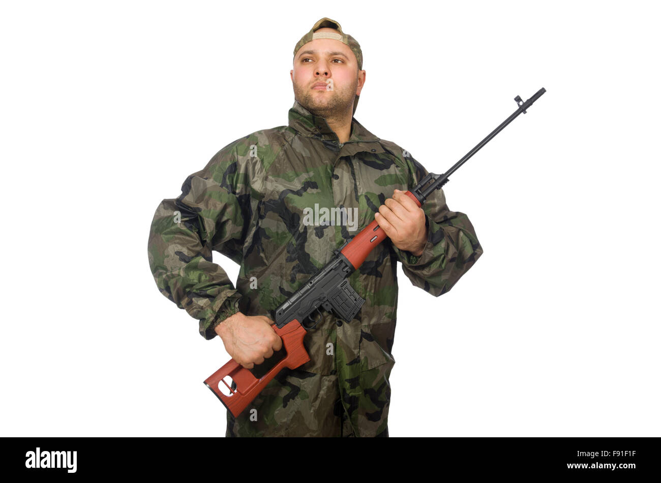 Young man in soldier uniform holding gun isolated on white Stock Photo ...