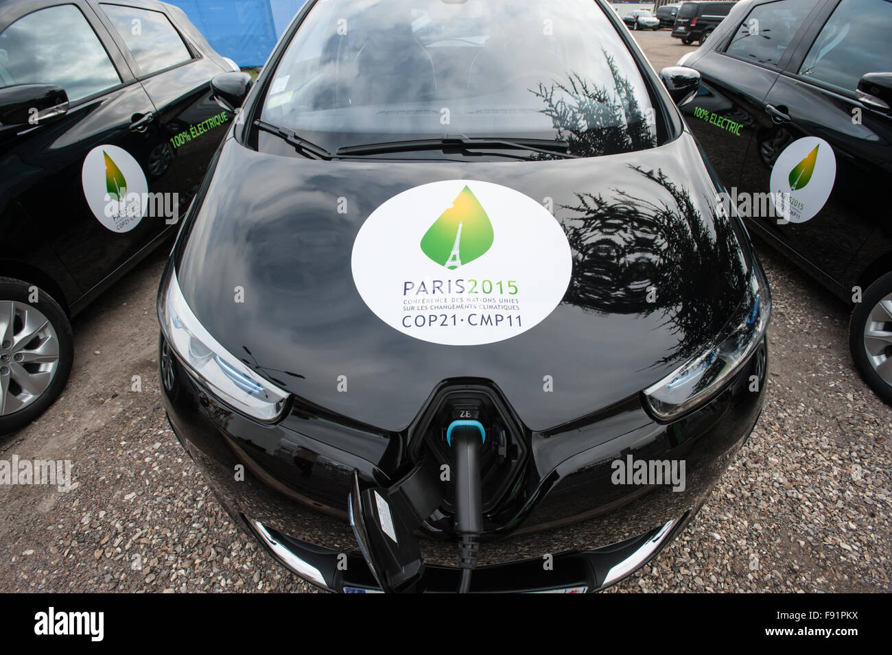 A fleet of electric cars charges in front fo the COP21 UN climate