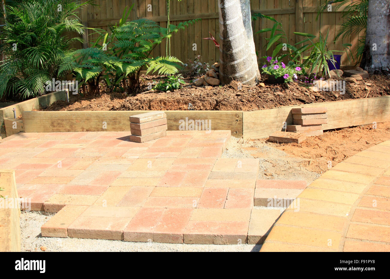 laying paving around the swimming pool Stock Photo Alamy