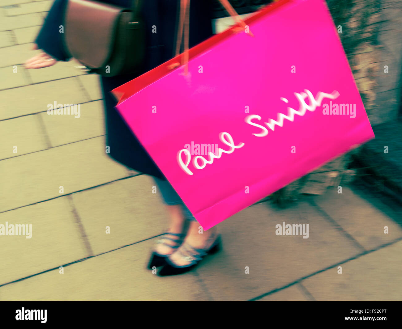 Young woman shopper with Paul Smith shopping bag in the West End of London UK Stock Photo