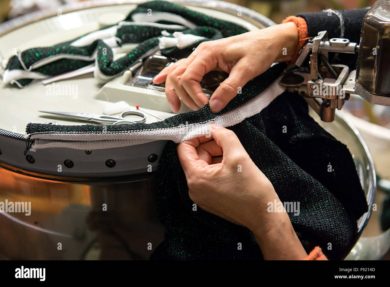 Looping machine operator working in a knitwear factory Stock Photo