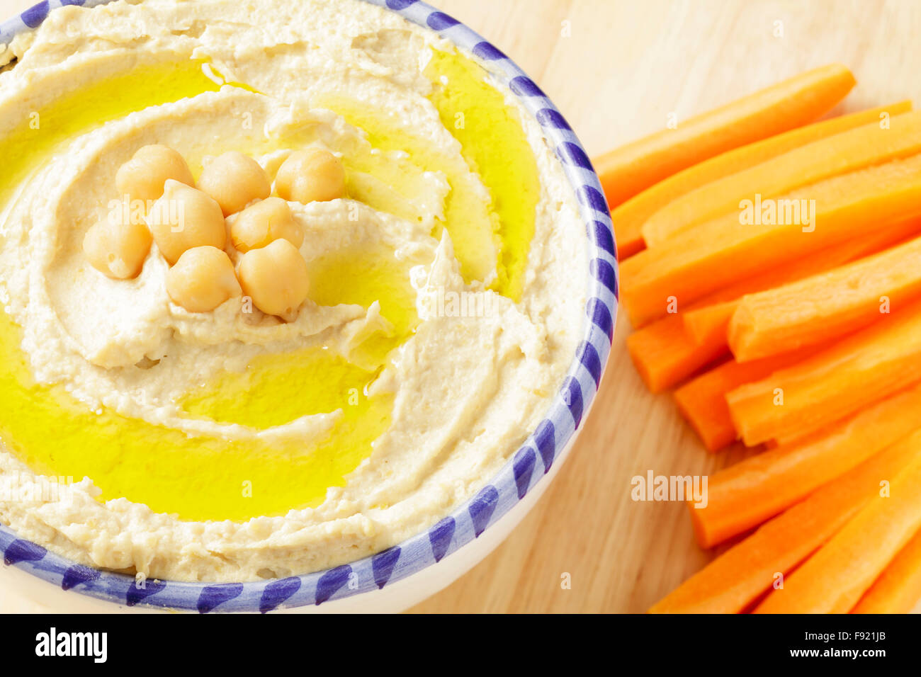 Hummus and carrot sticks Stock Photo