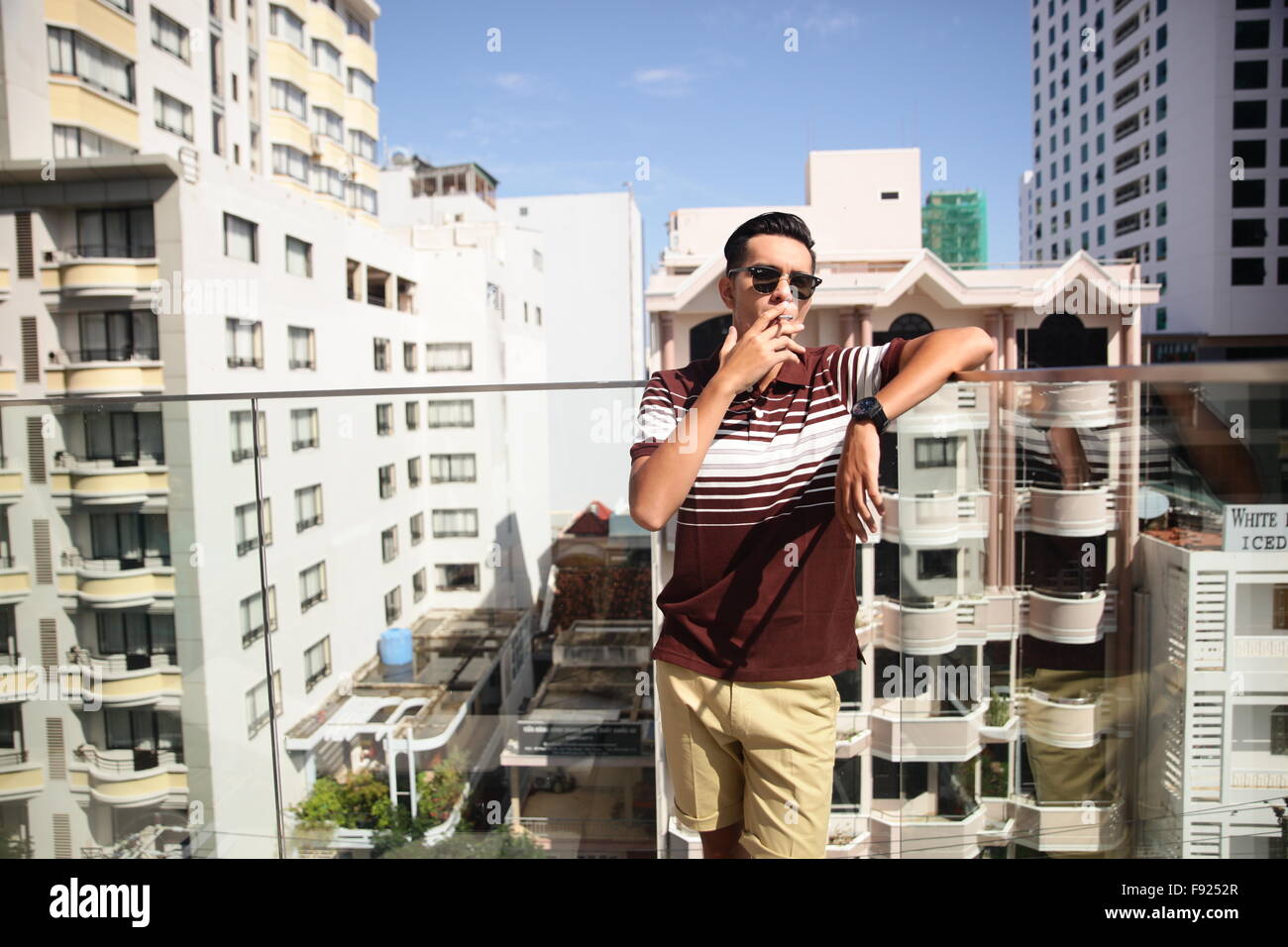 Smoking man on balcony hires stock photography and images Alamy