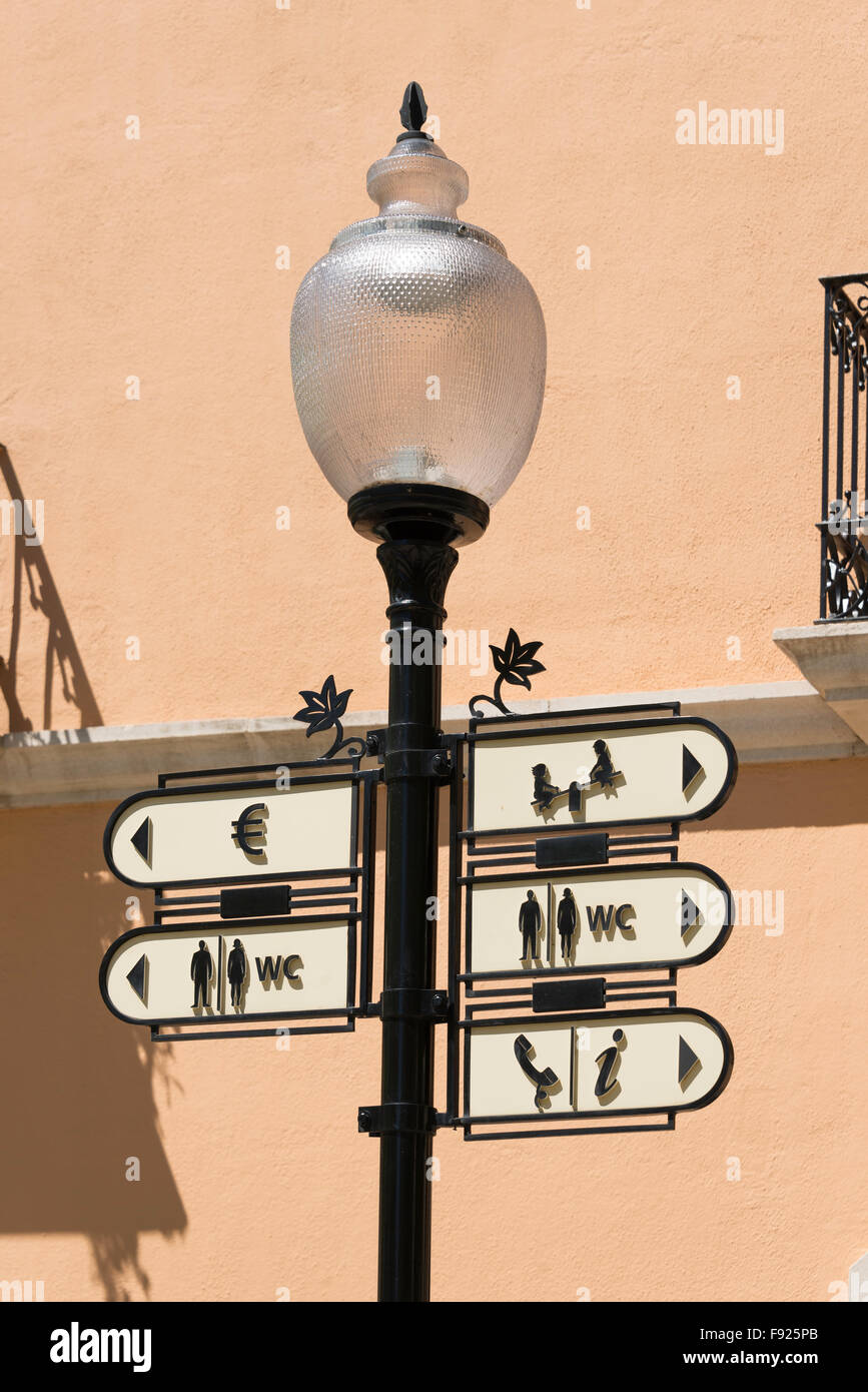 Street lamp with facility signs, La Roca Outlet Village, La Roca del Vallès, Barcelona, Province of Barcelona, Catalonia, Spain Stock Photo