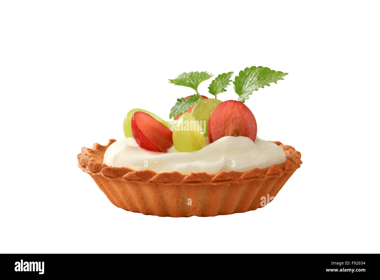 Small cream tart topped with fresh grapes Stock Photo