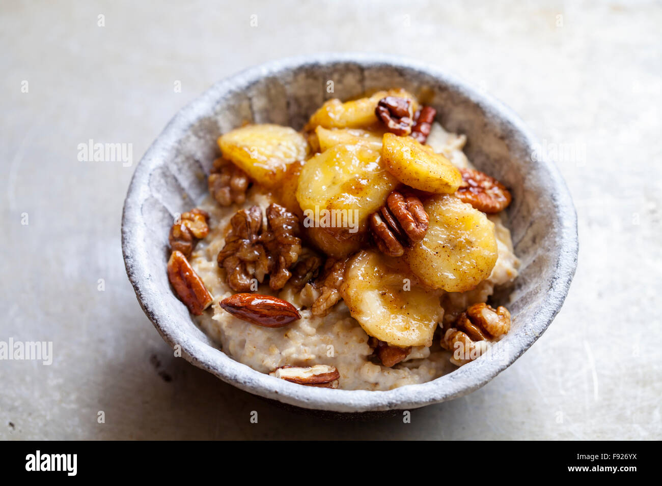 Porridge with caramelized banana and nuts Stock Photo Alamy