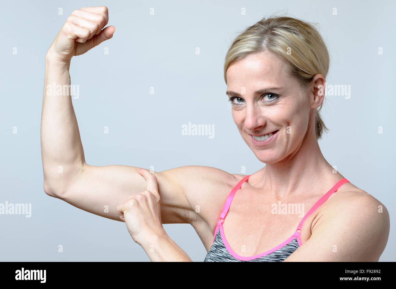 Woman shows biceps Stock Photo by ©everyonensk 152634154