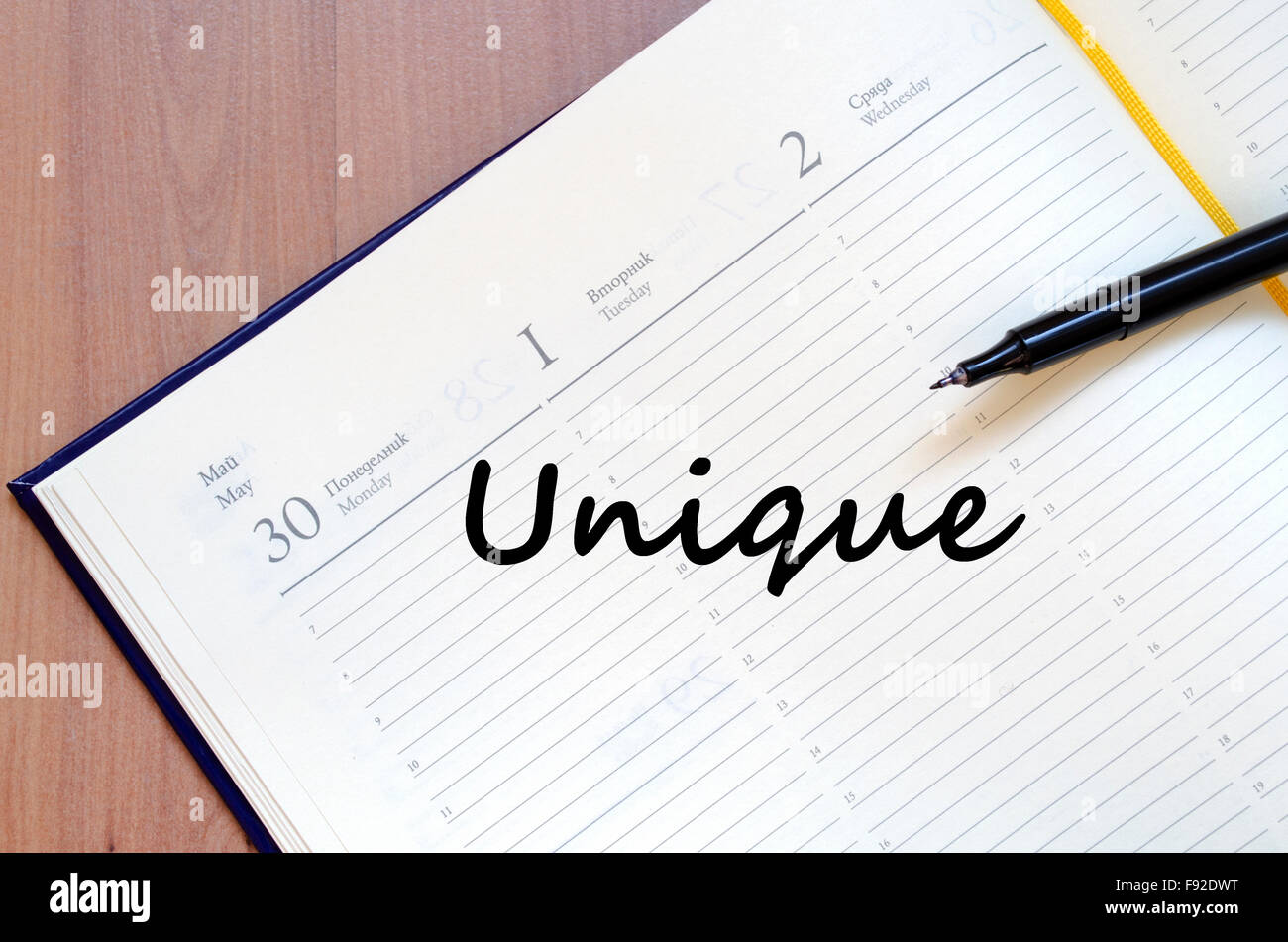 Unique text concept write on notebook with pen Stock Photo - Alamy
