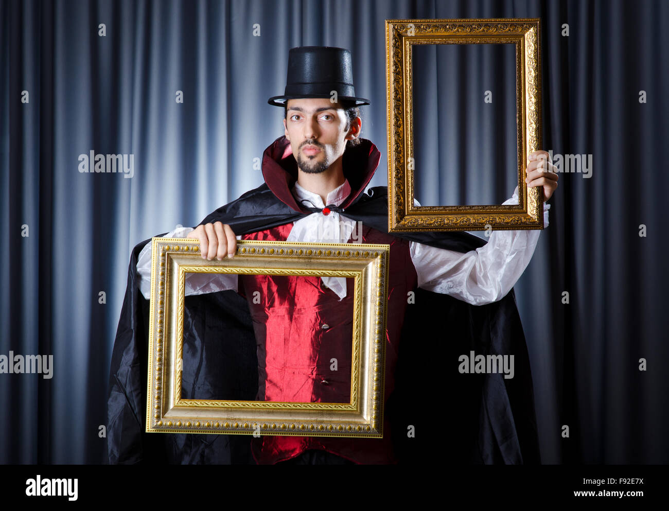 Magician with photoframe in studio Stock Photo Alamy