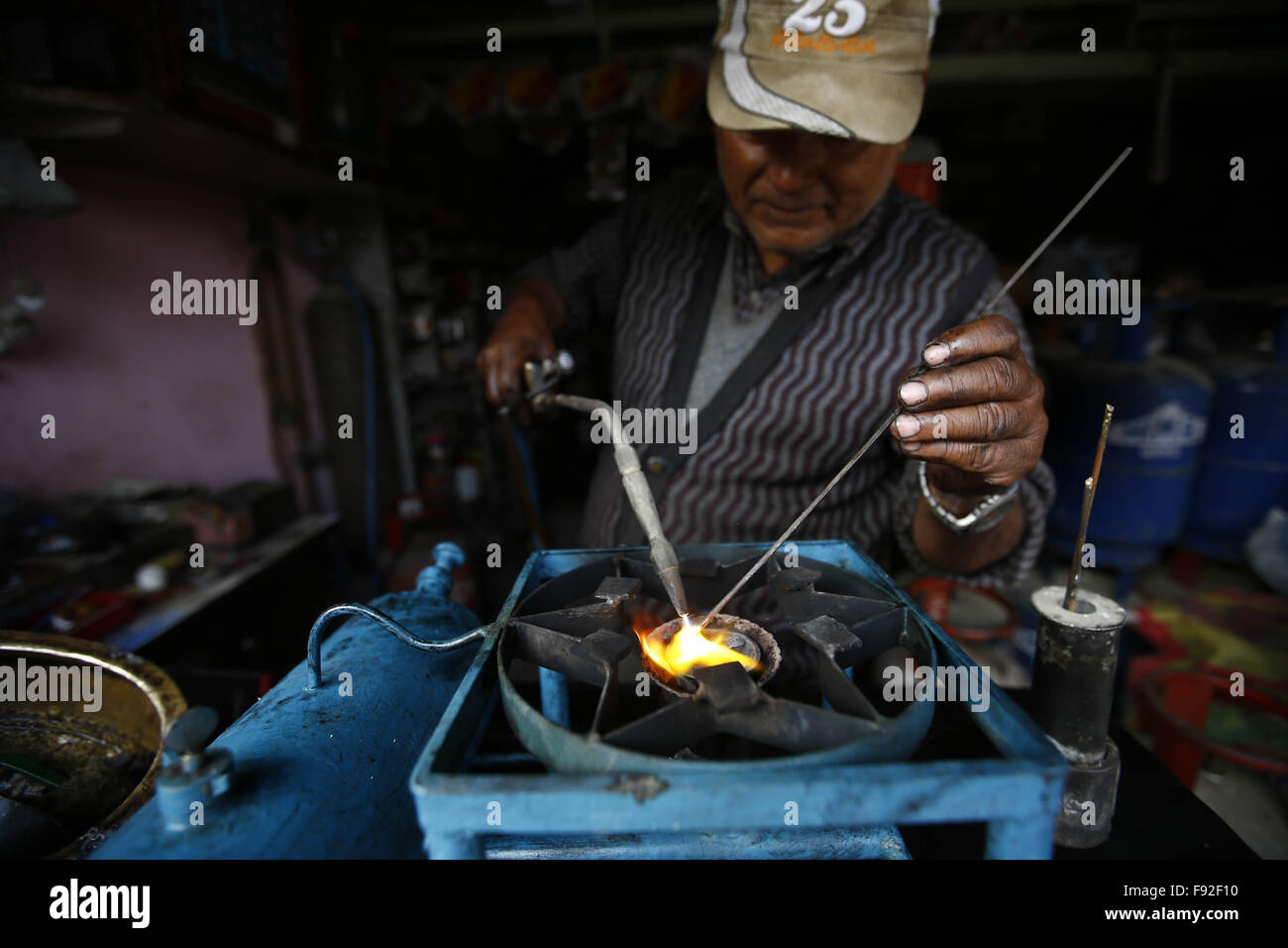 Kathmandu, Nepal. 13th Dec, 2015. A shopkeeper welding an old