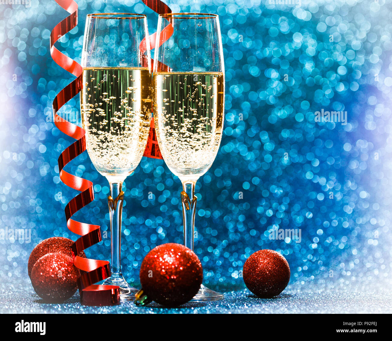 Two glasses of champagne with lights in the background Stock Photo