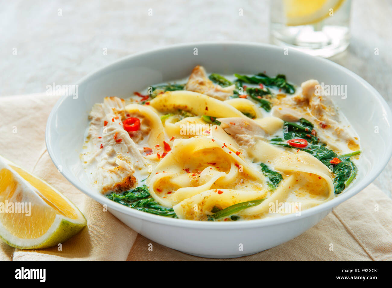 Coconut Curry Chicken Soup with noodles in a plate Stock Photo