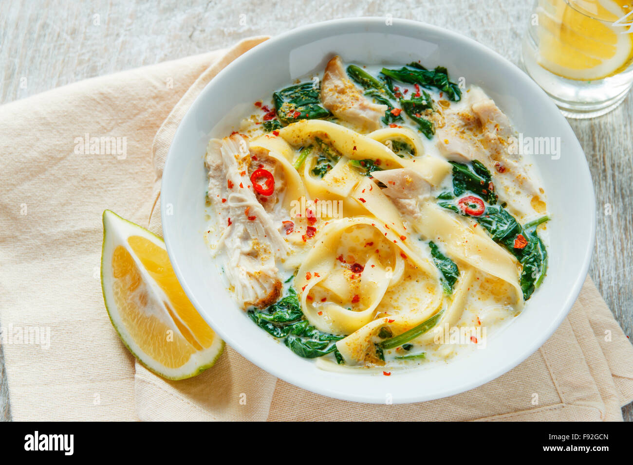 Coconut Curry Chicken Soup with noodles in a plate Stock Photo