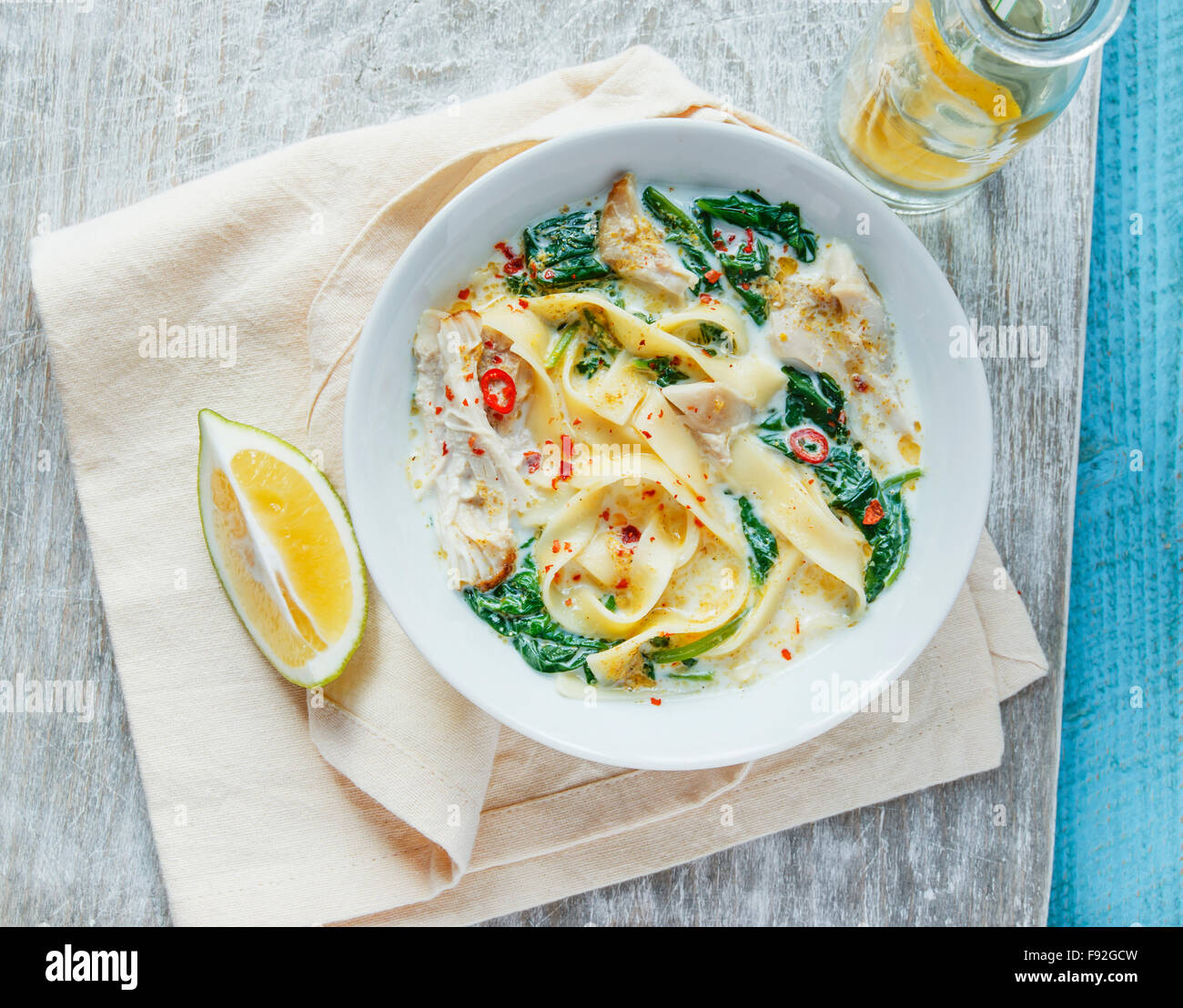 Coconut Curry Chicken Soup with noodles in a plate Stock Photo
