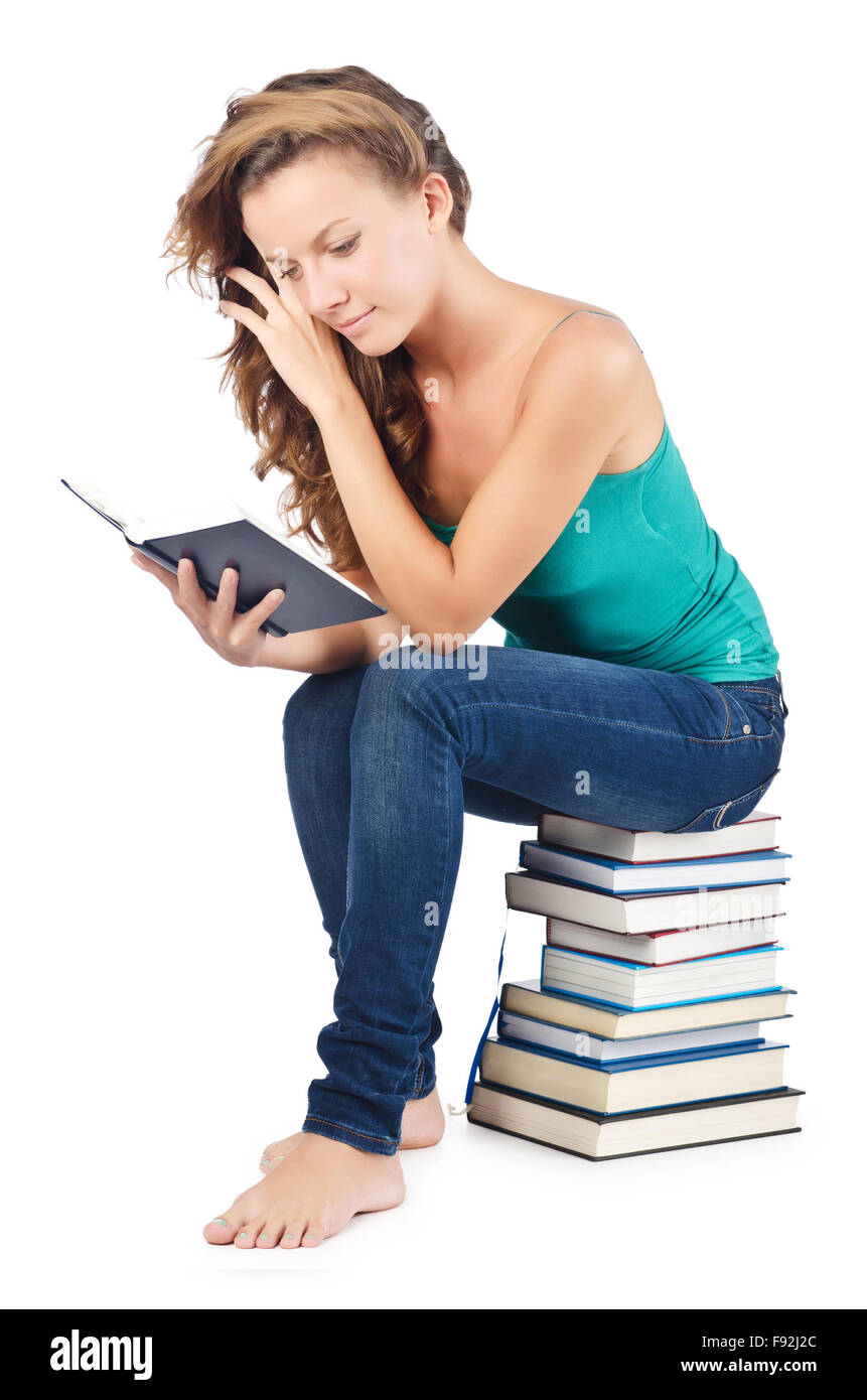 Student sitting on stack of books Stock Photo - Alamy