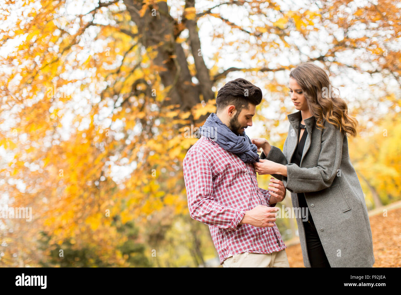 Young couple in the autumn park Stock Photo - Alamy
