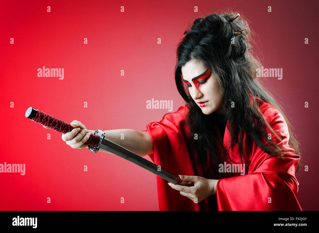 Female sword warriod in dark studio Stock Photo