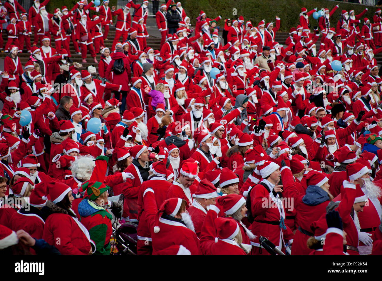 Edinburgh, UK. 13th December, 2015. West Princes Street Gardens, Scotland Santa’s and Santa’s Little Helpers  ran walked and strolled around West Princes Street Gardens. The Edinburgh Santa Fun Run & Walk raises funds for  the 'When You Wish upon a Star' charity Stock Photo