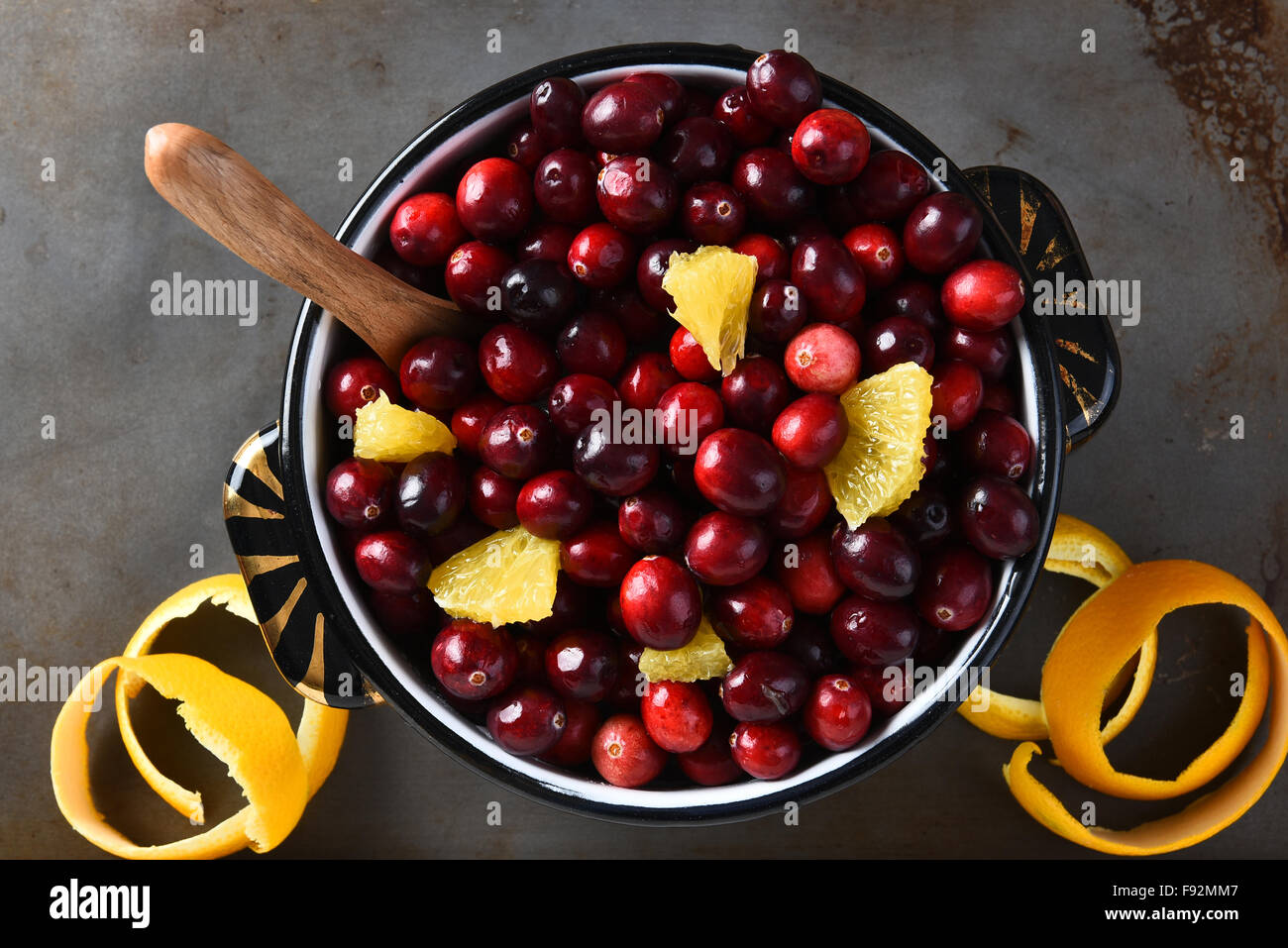 A pot full of fresh cranberries and orange pieces,. High angle view of the traditional Thanksgiving holiday side dish. Stock Photo