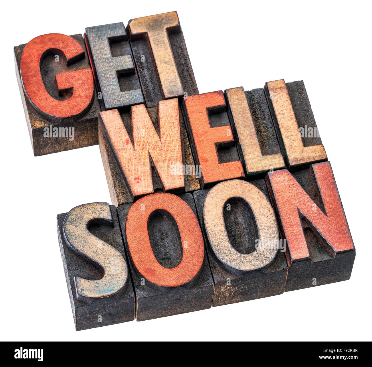Get well soon wishes in letterpress wood type printing blocks stained by inks, isolated on white Stock Photo