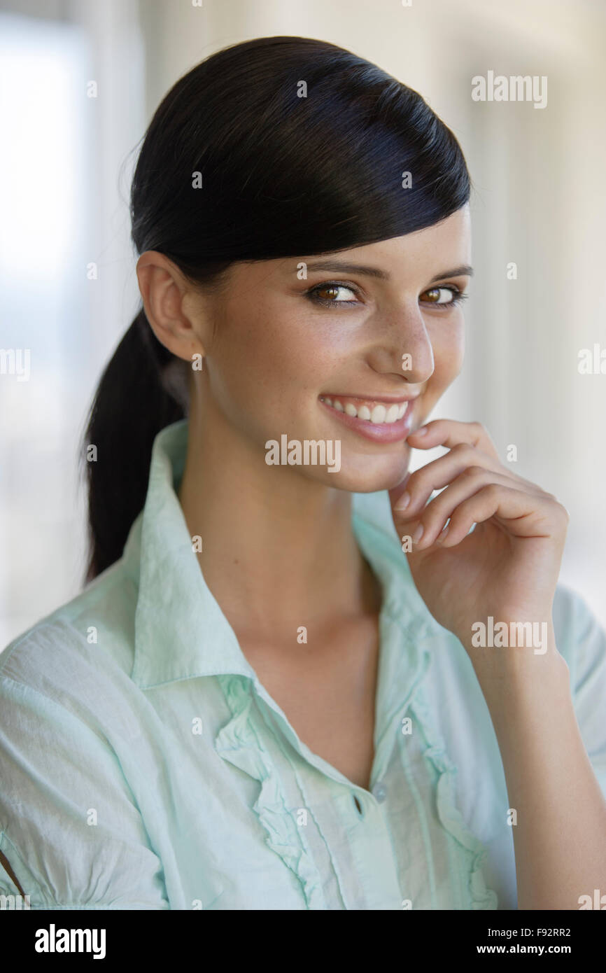 Portrait darkhaired young woman indoors Stock Photo