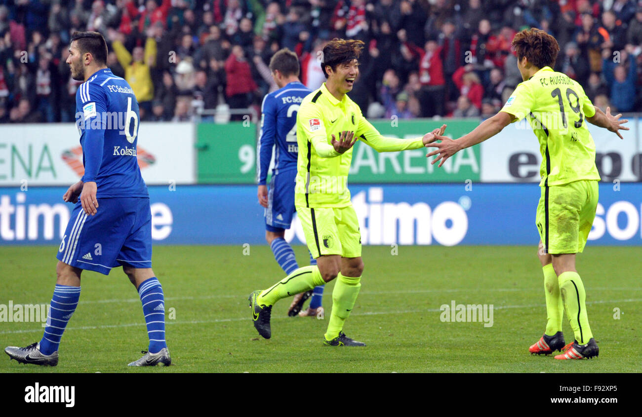 Augsburg, Germany. 13th Dec, 2015. Augsburg's Jeong- Ho Hong (L) and Ja-Cheol Koo celebrate after the 1-0 goal during the German Bundesliga soccer match between FC Augsburg and FC Schalke 04 in Augsburg, Germany, 13 December 2015. Photo: STEFAN PUCHNER/dpa (EMBARGO CONDITIONS - ATTENTION - Due to the accreditation guidelines, the DFL only permits the publication and utilisation of up to 15 pictures per match on the internet and in online media during the match)/dpa/Alamy Live News Stock Photo