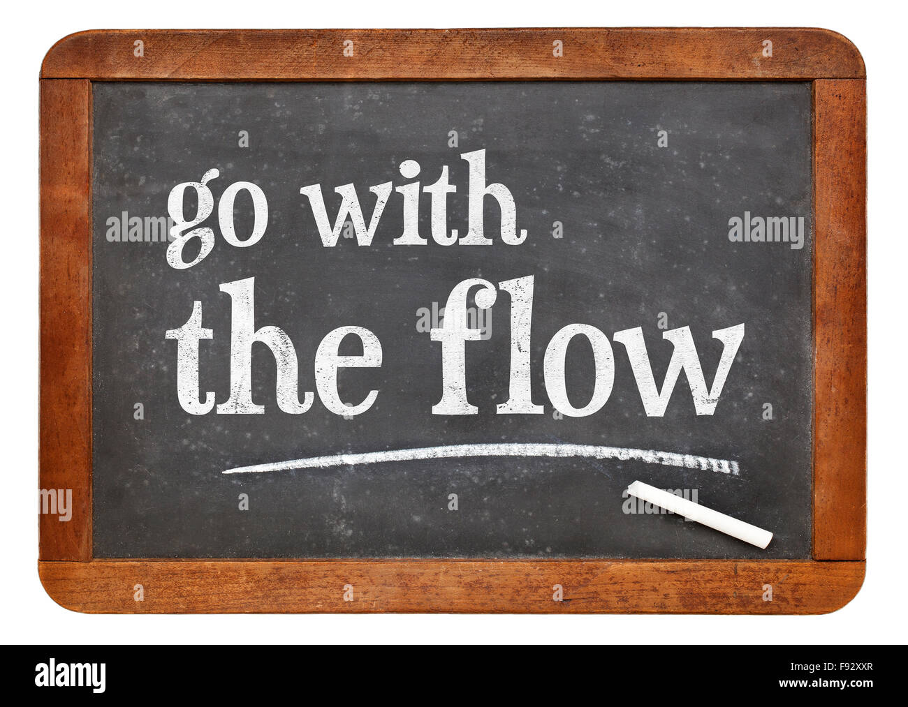Go with the flow advice - white chalk text  on a vintage slate blackboard Stock Photo