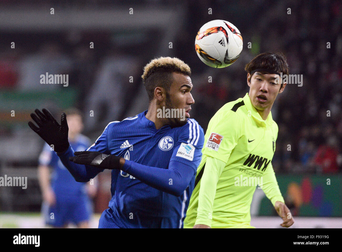 Augsburg, Germany. 13th Dec, 2015. Augsburg's Jeong- Ho Hong (R) and Eric Maxim Choupo-Moting from Schalke vie for the ball during the German Bundesliga soccer match between FC Augsburg and FC Schalke 04 in Augsburg, Germany, 13 December 2015. Photo: STEFAN PUCHNER/dpa (EMBARGO CONDITIONS - ATTENTION - Due to the accreditation guidelines, the DFL only permits the publication and utilisation of up to 15 pictures per match on the internet and in online media during the match)/dpa/Alamy Live News Stock Photo
