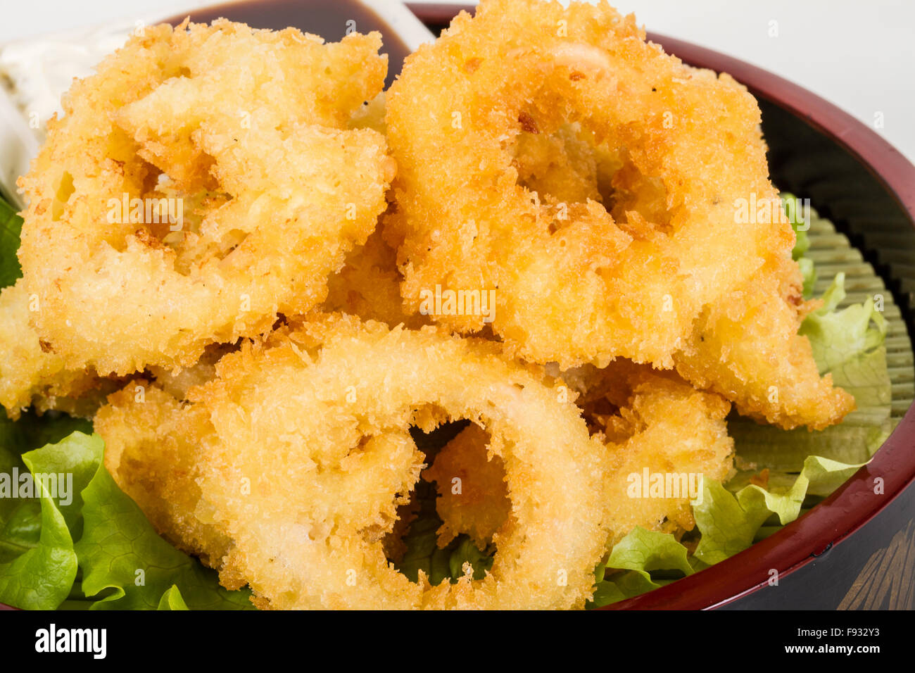 Deep batter fried squid rings calamari with green salad Stock Photo - Alamy