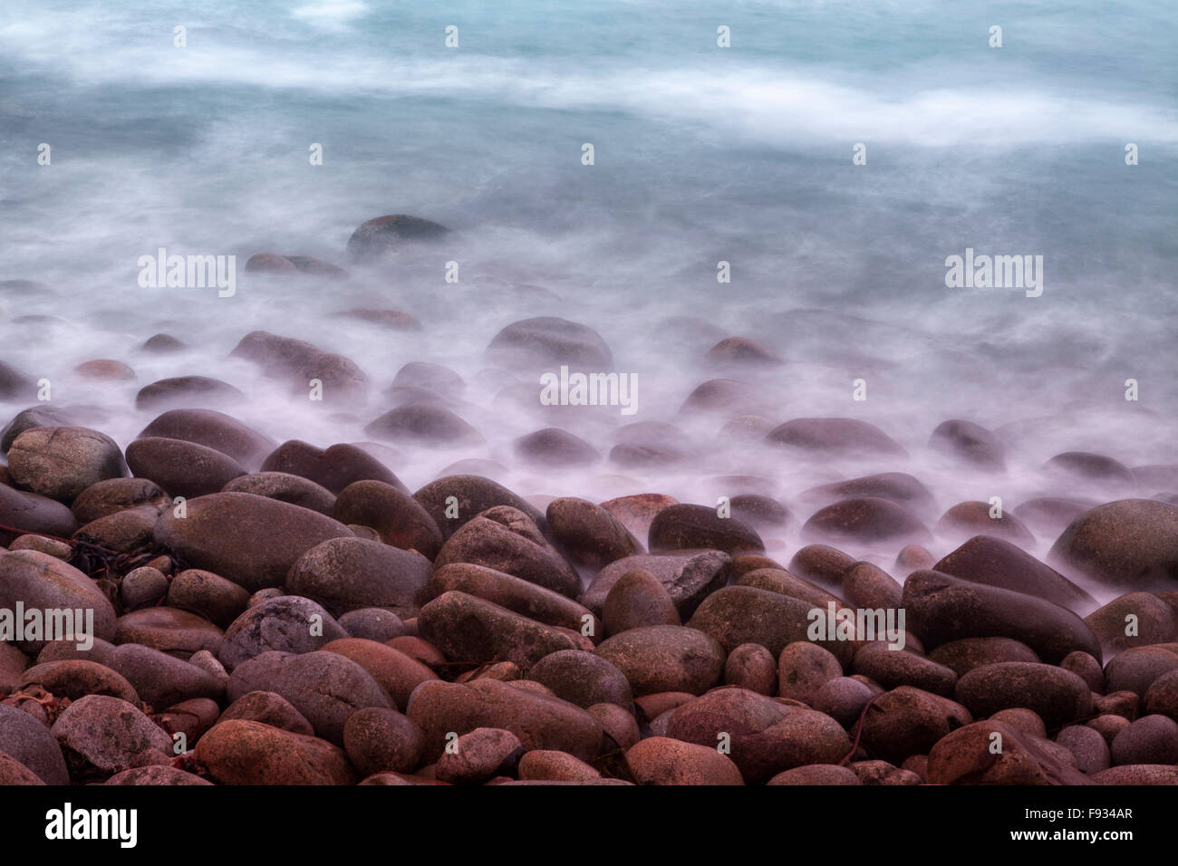 Waves lapping over pebbles on the beach, Porth Nanven, near St Just, Cornwall, England, UK Stock Photo