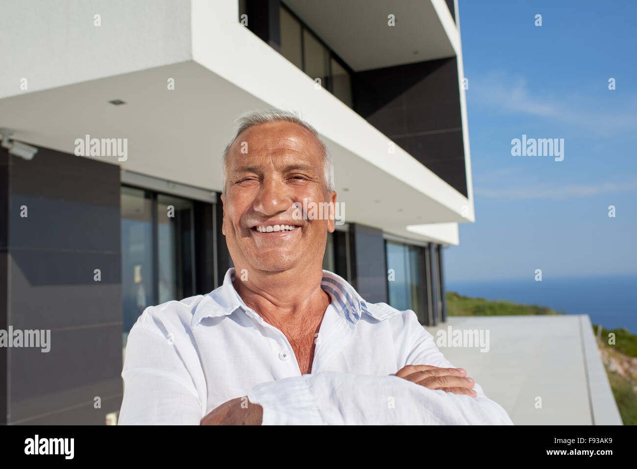 senior man in front of luxury modern home villa Stock Photo Alamy