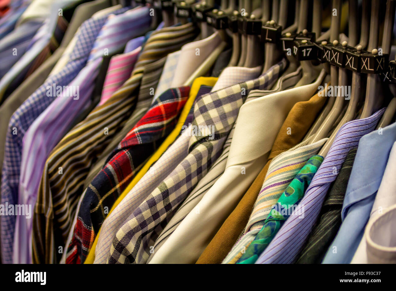 Male shirts hanging in a charity shop, close up Stock Photo