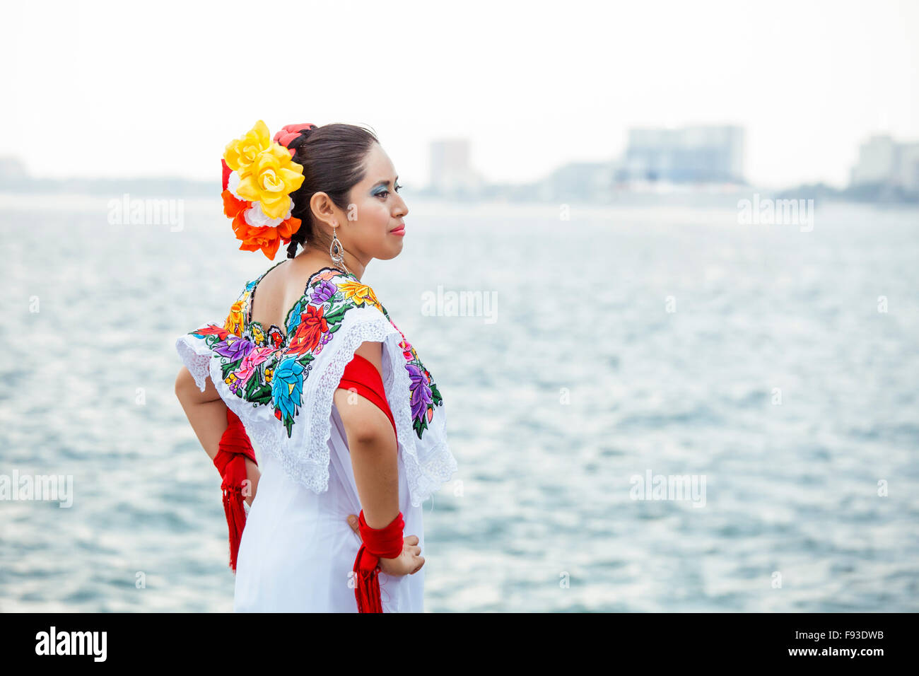 A folkloric dancer strikes a pose on the boardwalk in Puerto Vallarta, Mexico. Stock Photo