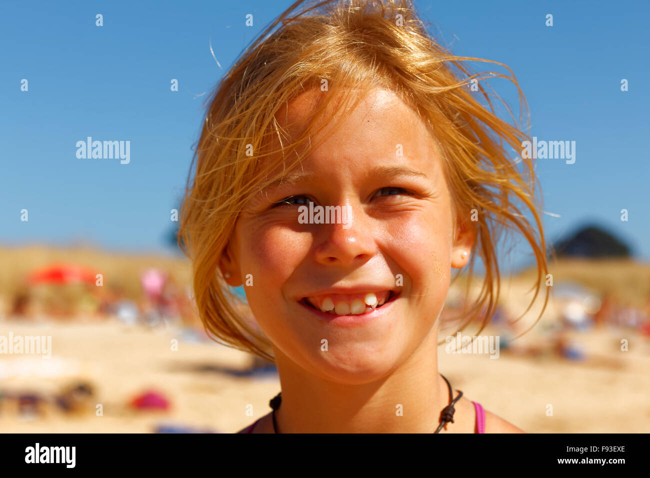 Portrait of a happy and attractive 10 years old girl at the beach in summer time Stock Photo