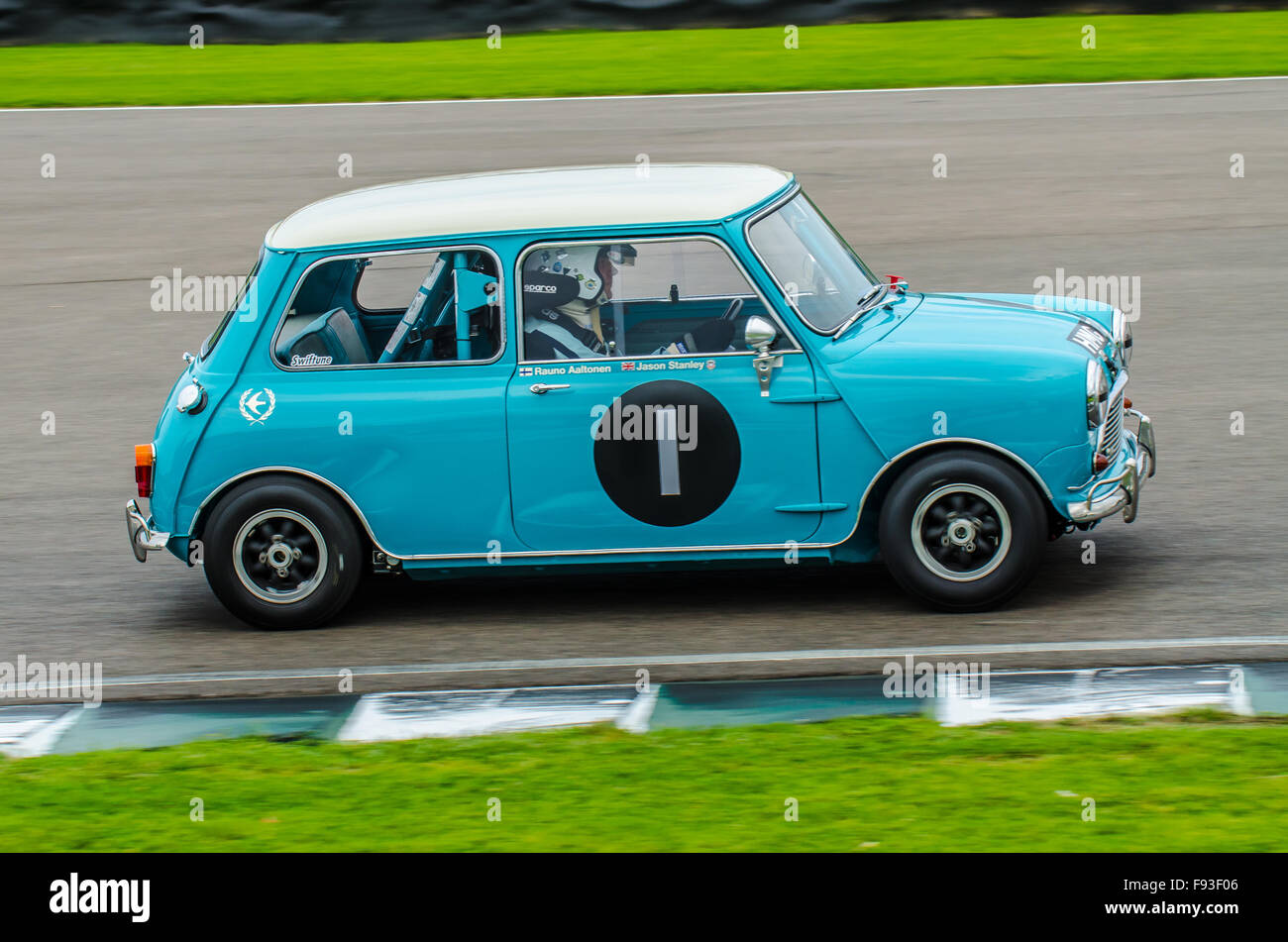 The Mini is a small economy car made by the British Motor Corporation (BMC) and its successors from 1959 until 2000. Racing at the Goodwood Revival Stock Photo