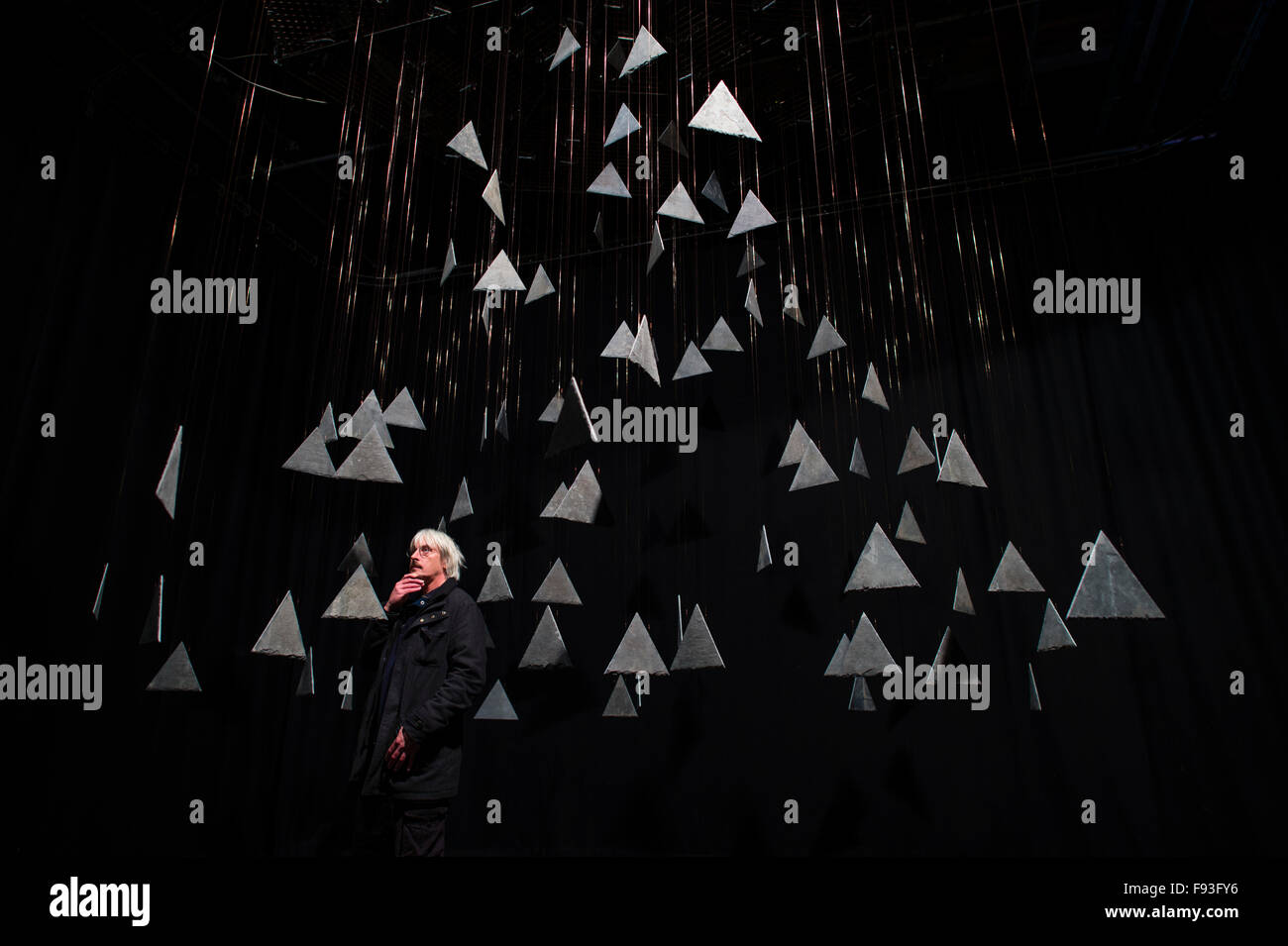 The Fractal Clock, created by artist and performer Richard Downing (pictured standing amongst the hanging slates) , at Castle Theatre Aberystwyth , consisting of 180 triangles of slate, each rotating at a different rate, all coming together to form the complete pattern, viewable from a fixed point in the auditorium,  once every hour. Stock Photo