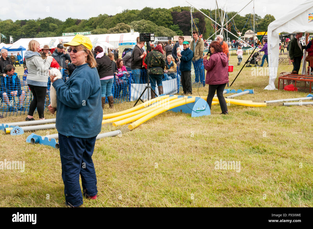 A woman with a white ferret ready for racing at Holkham Country Fair. Stock Photo