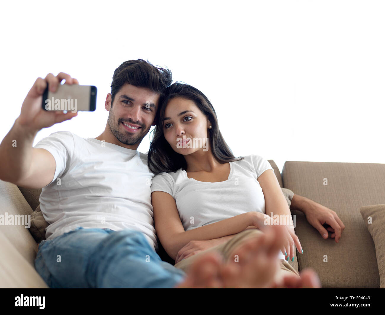cheerful happy young couple making selfie together at home Stock Photo ...