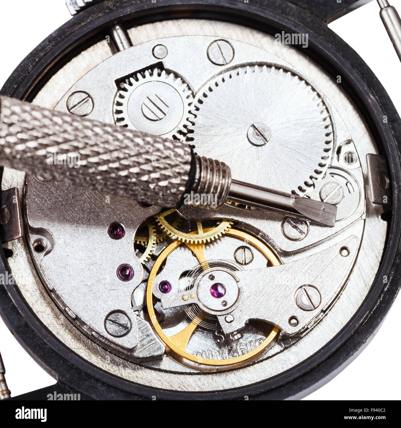 adjusting old mechanic wristwatch top view of screwdriver on open
