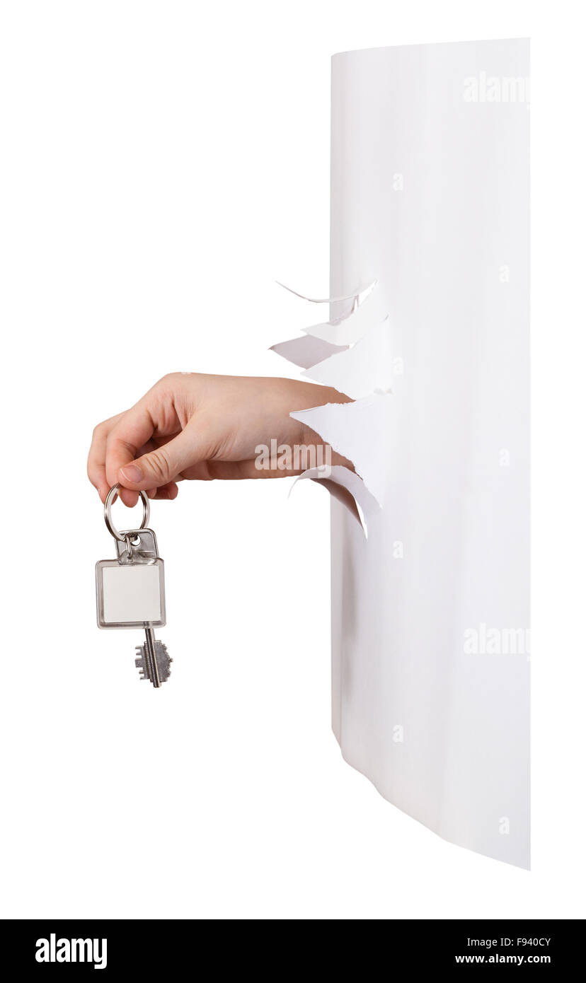 side view of hand holds the keyring through a hole in a sheet of paper isolated on white background Stock Photo