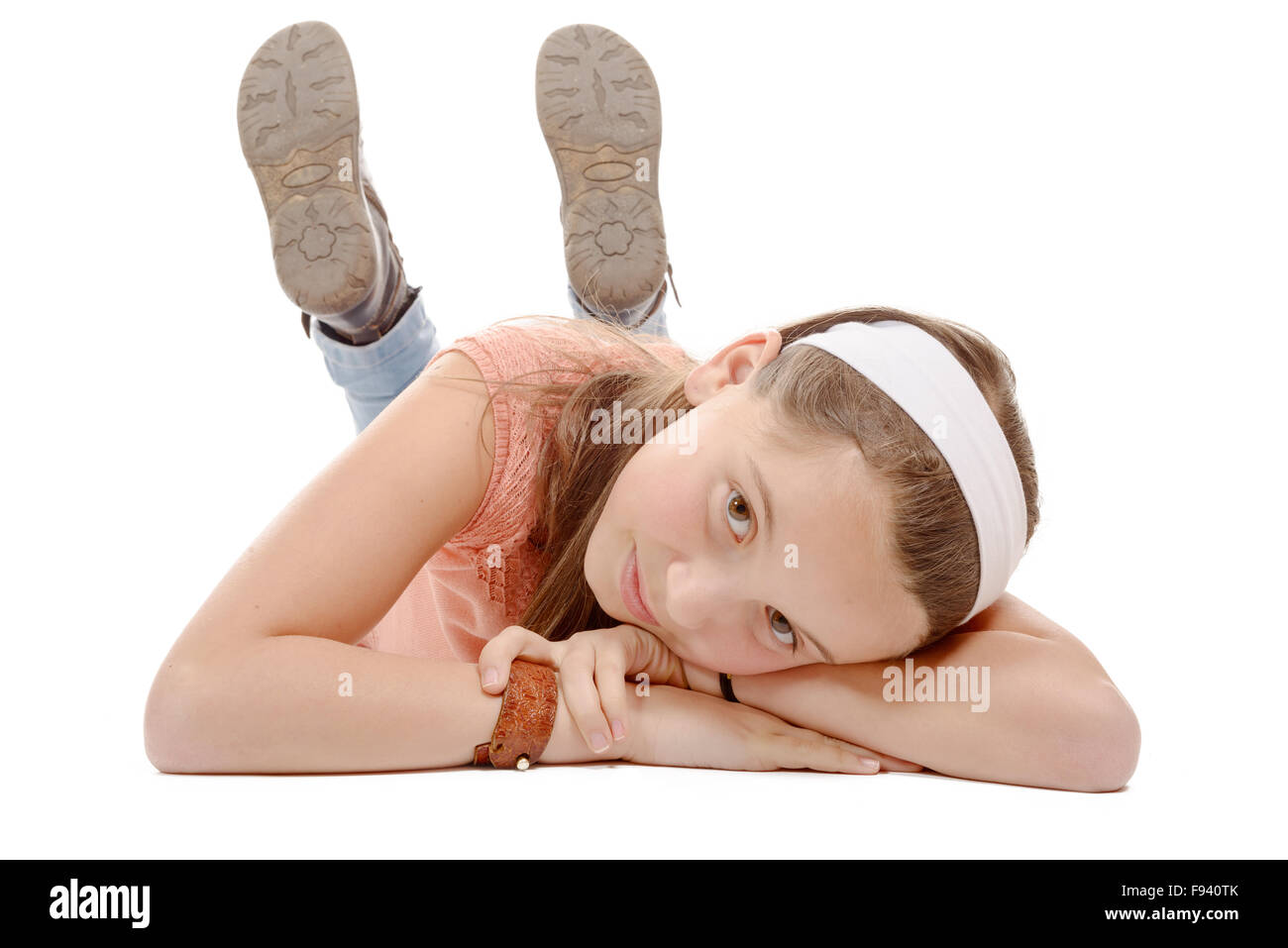 a portrait of smiling little girl lying on the floor isolated on white ...