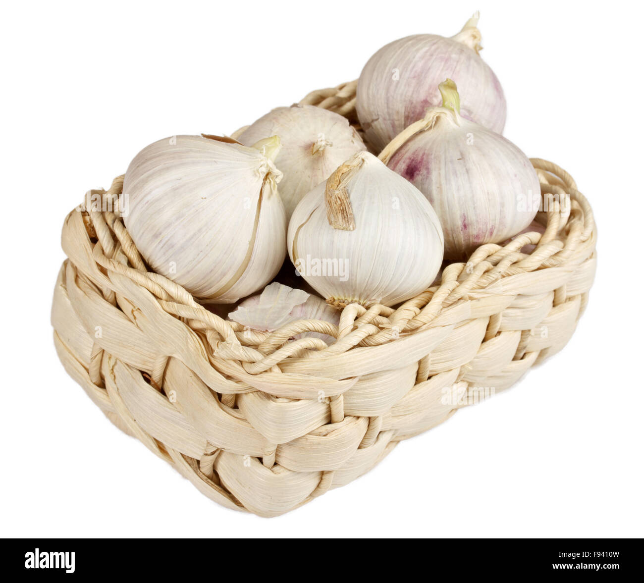Several garlic onions in a basket isolated over white Stock Photo - Alamy