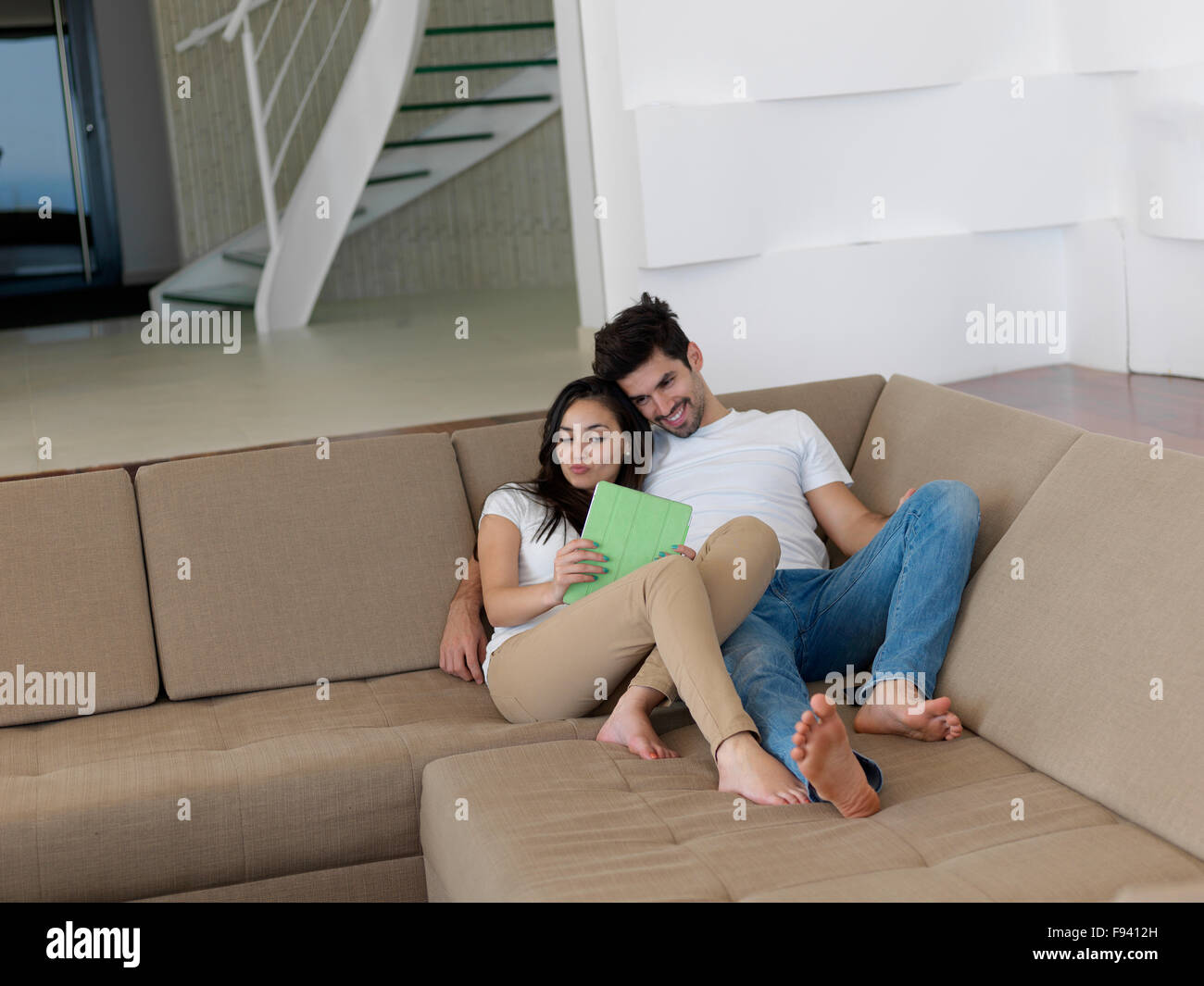 cheerful happy young couple making selfie together at home Stock Photo ...