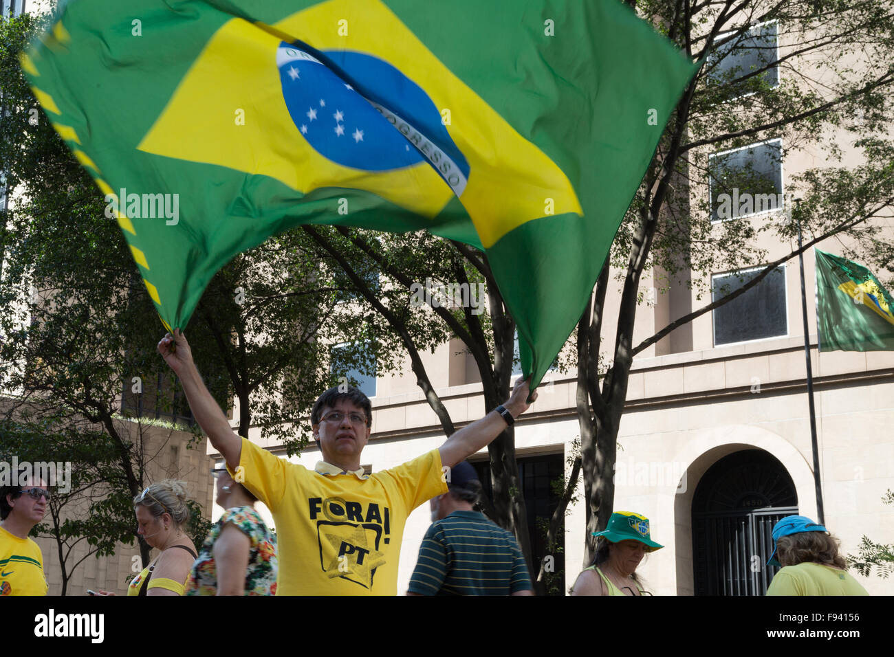 Sao Paulo, Brazil. 13th December, 2015. Demonstrator wearing a t-shirt written in Portuguese 'Fora PT' (in English 'Out PT') waves a Brazil flag during a demonstration calling for the impeachment of Brazil's President Dilma Rousseff in Paulista avenue, Sao Paulo, Brazil. Credit: Andre M. Chang/Alamy Live News Stock Photo