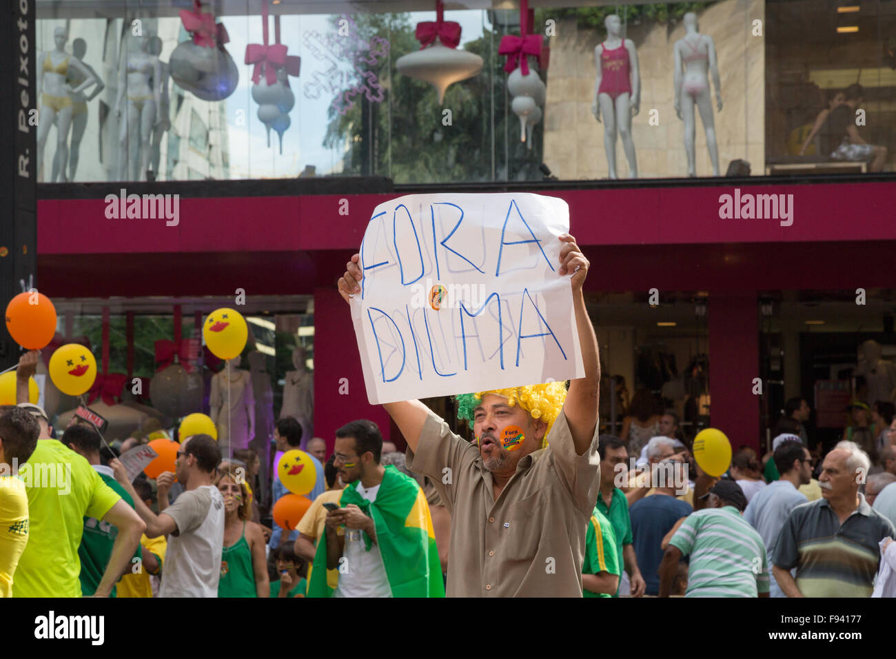 Sao Paulo, Brazil. 13th December, 2015. A demonstrator with poster written in Portuguese 'Fora Dilma' (in English 'Out Dilma') is seen during a demonstration calling for the impeachment of Brazil's President Dilma Rousseff in Paulista avenue, Sao Paulo, Brazil. Credit: Andre M. Chang/Alamy Live News Stock Photo