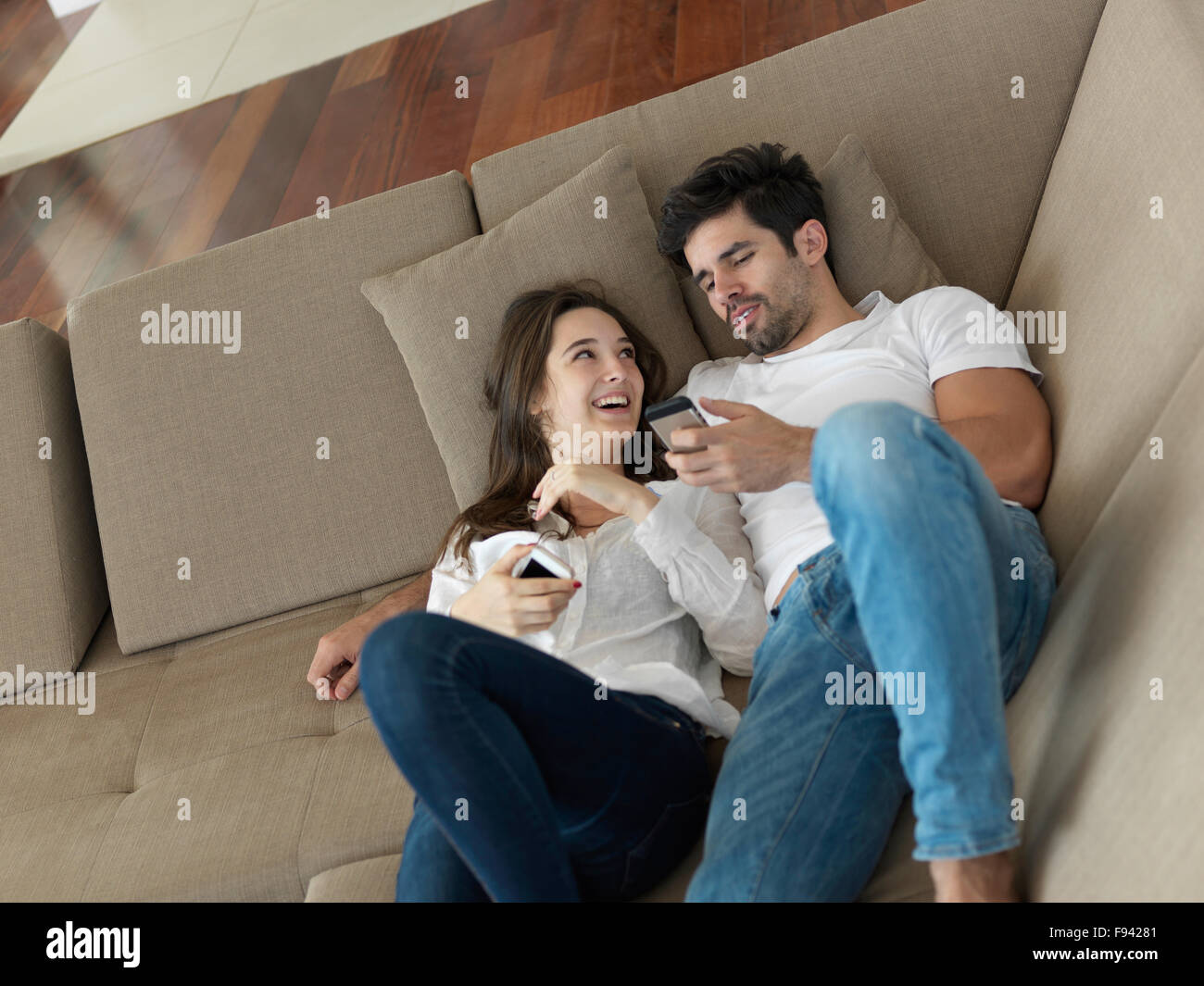 cheerful happy young couple making selfie together at home Stock Photo ...